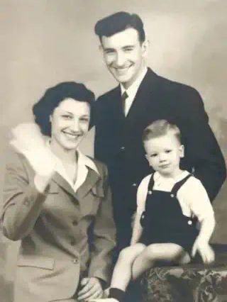 Animate old photos: a toddler in a creased sepia photo smiles and waves with both hands